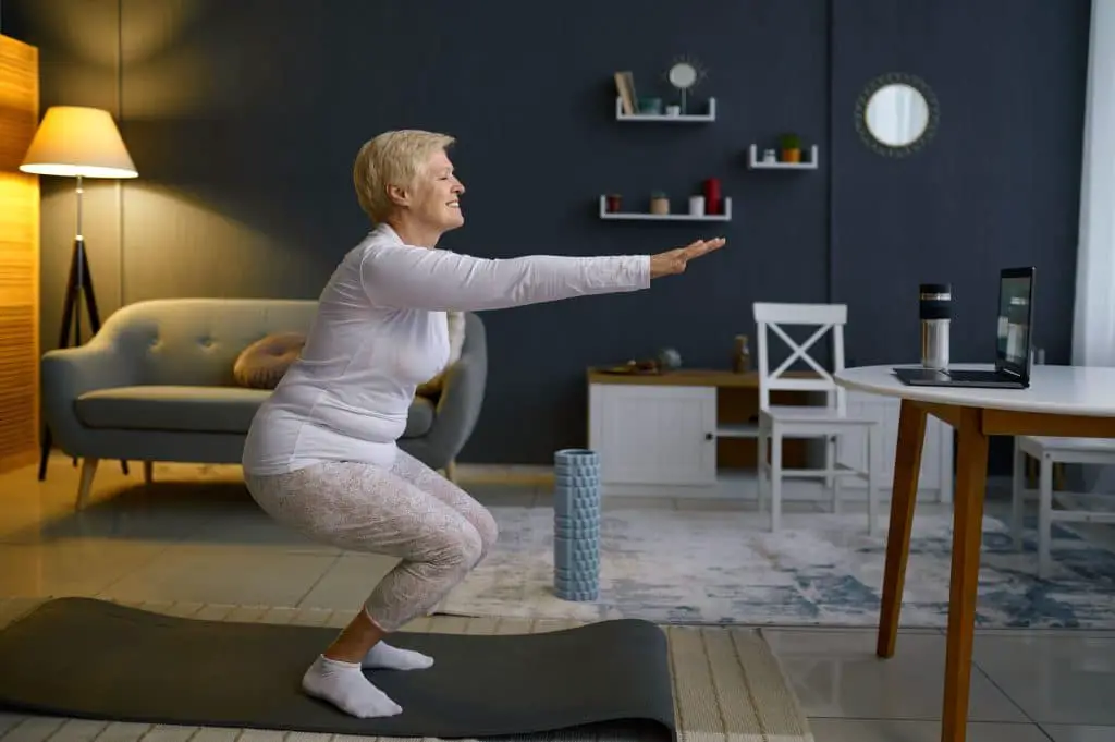 a senior women doing squat exercises at home