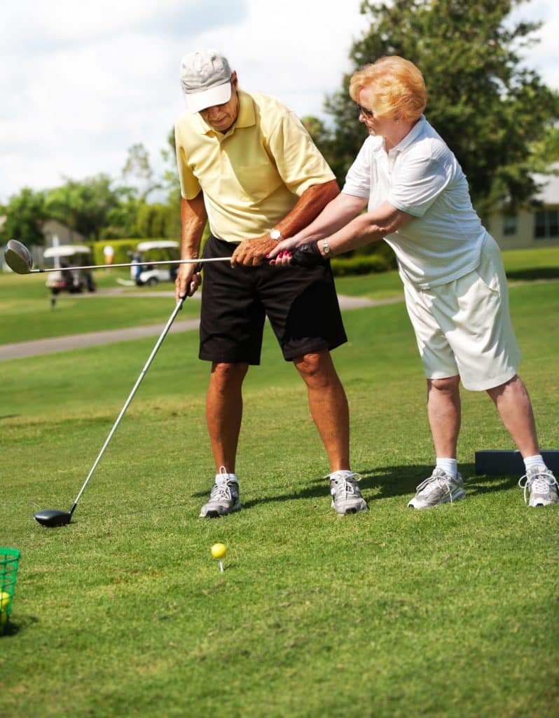 Two seniors playing golf