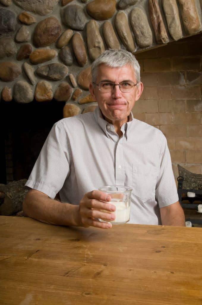 Senior man drinking a glass of milk