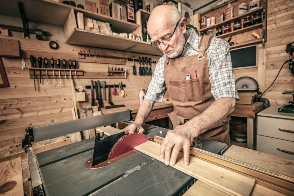 Elderly man doing wood working
